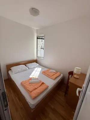 a bedroom with a bed with two towels on it at Jadran Rafailovic in Rafailovici