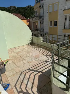 a shadow of a building on a patio at Jadran Rafailovic in Rafailovici