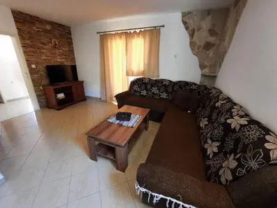 a living room with a couch and a coffee table at Apartmani Šćekić in Bar