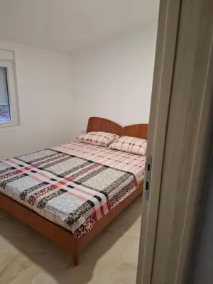 a bedroom with a bed with a quilt on it at Apartmani Šćekić in Bar