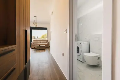 a bathroom with a toilet and a couch at SeaSide Luxury Apartments in Ulcinj