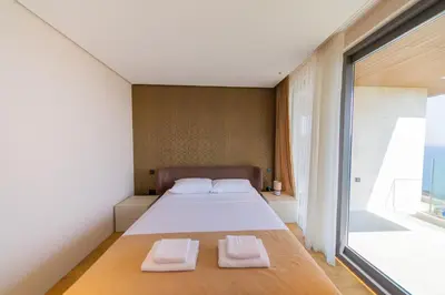 a bedroom with a bed and a large window at Villa Patria in Budva