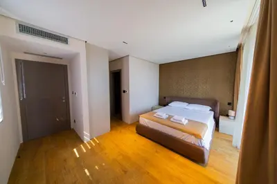 a bedroom with a bed with two towels on it at Villa Patria in Budva