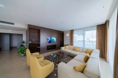 a living room with a couch and chairs and a tv at Villa Patria in Budva