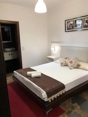 a bedroom with a large bed with two pillows on it at Apartments FourRoses in Ulcinj