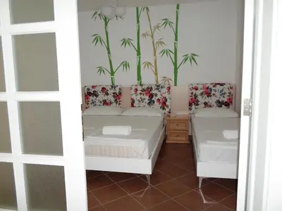 a room with two beds and a window at Apartments FourRoses in Ulcinj