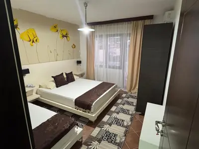 a bedroom with a bed and a mirror at Apartments FourRoses in Ulcinj