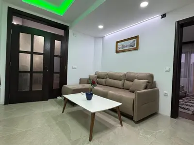 a living room with a couch and a table at Apartments FourRoses in Ulcinj