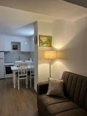 a living room with a couch and a kitchen at Apartman Budva Centar in Budva