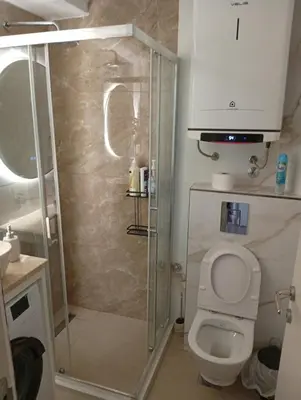 a bathroom with a shower with a toilet and a sink at Apartman Budva Centar in Budva