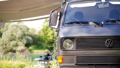 a van parked under a tent next to a table at Camperlife Montenegro in Podgorica