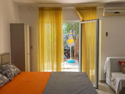 a bedroom with a bed and a sliding glass door at Apartment Sara in Petrovac na Moru