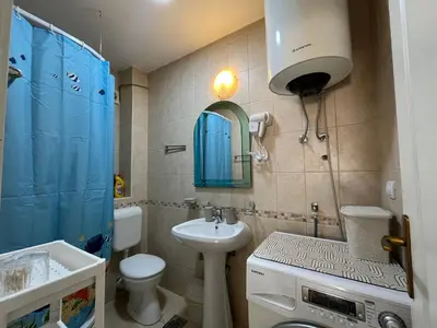 a bathroom with a sink and a toilet and a mirror at Apartment Sara in Petrovac na Moru