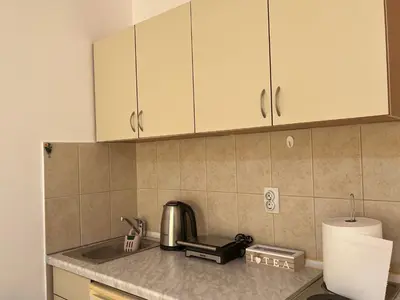 a kitchen with white cabinets and a sink at Apartment Sara in Petrovac na Moru