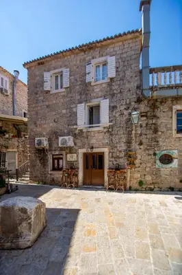 a large stone building with a large stone courtyard at Charming Apartment in The Old Town in Budva