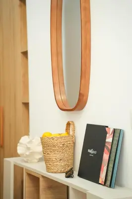 a wicker basket sitting on a shelf with a mirror at Helen studio apartment in Kotor