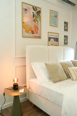a bedroom with a bed and a table with a candle at Helen studio apartment in Kotor