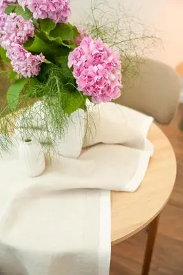 a vase filled with pink flowers on a table at Helen studio apartment in Kotor