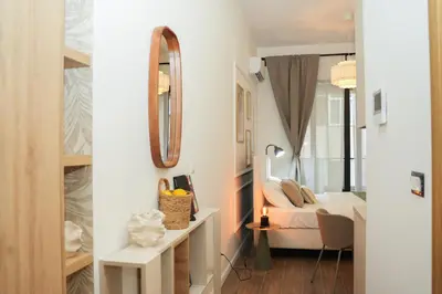 a bedroom with a bed and a mirror at Helen studio apartment in Kotor