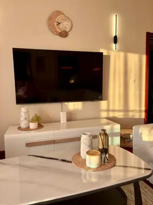 a living room with a table and a tv at Mia Bella in Bar