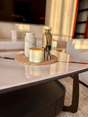 a table with a tray with a candle and vases on it at Mia Bella in Bar