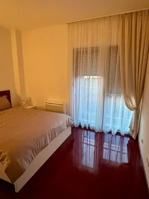a bedroom with a bed and a window with curtains at Mia Bella in Bar