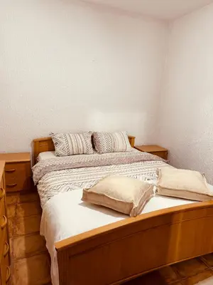 a bedroom with a large wooden bed with pillows at Levant in Sutomore