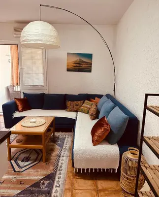 a living room with a blue couch and a table at Levant in Sutomore