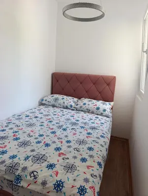 a bedroom with a bed with a floral bedspread at Sofi in Sutomore