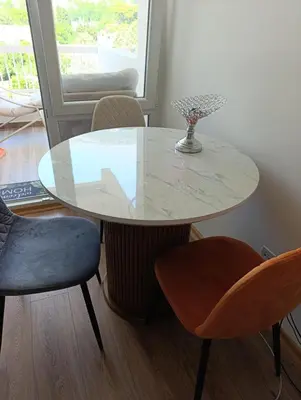 a white table with two chairs and a vase on it at Sofi in Sutomore
