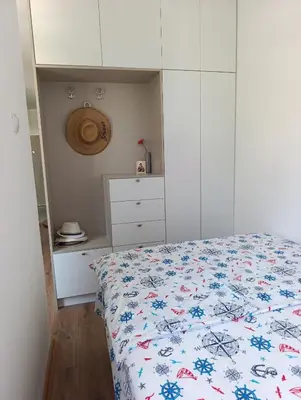 a bedroom with a bed and a white cabinet at Sofi in Sutomore