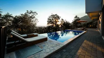 a swimming pool with a bench and a house at Villa Amara -Luxury Villa with Private Pool & Hot Tub in Bar