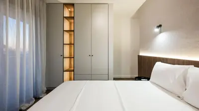 a bedroom with a large white bed and a window at Villa Amara -Luxury Villa with Private Pool & Hot Tub in Bar