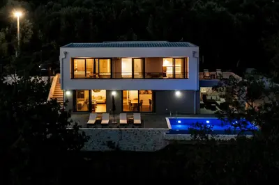 a house at night with a pool in front of it at Villa Amara -Luxury Villa with Private Pool & Hot Tub in Bar