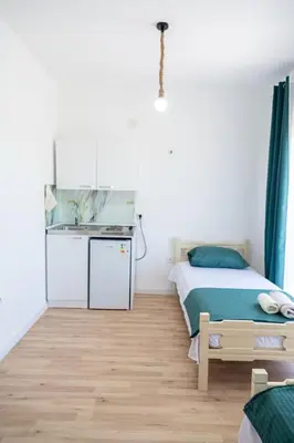 a small bedroom with a bed and a sink at Odore di mare in Ulcinj