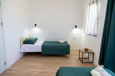 a small room with two beds and a table at Odore di mare in Ulcinj