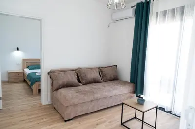 a living room with a couch and a bed at Odore di mare in Ulcinj