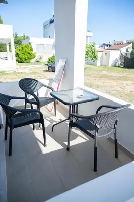 a patio with two chairs and a table and a table and chairs at Odore di mare in Ulcinj