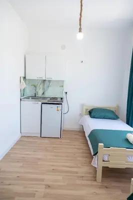 a small bedroom with a bed and a sink at Odore di mare in Ulcinj