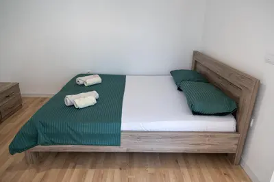 a bed with two pillows on it in a room at Odore di mare in Ulcinj