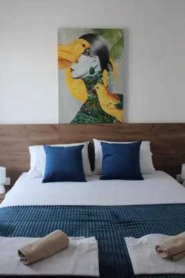 a bedroom with a bed with a painting of a woman at AMD - stan 211 in Bar