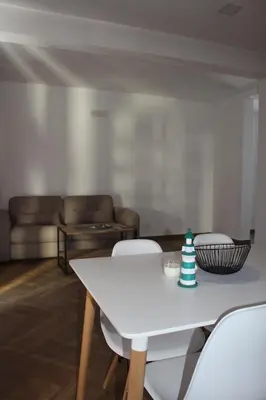 a living room with a white table and chairs at AMD - stan 211 in Bar