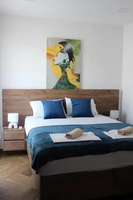 a bedroom with a bed with a painting on the wall at AMD - stan 211 in Bar