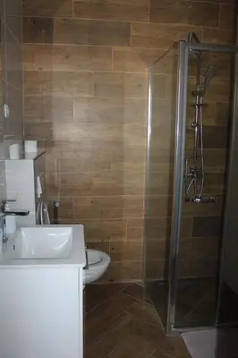 a bathroom with a shower and a sink and a toilet at AMD - stan 211 in Bar