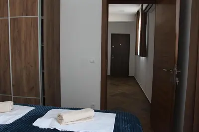 a bedroom with a bed with two towels on it at AMD - stan 211 in Bar