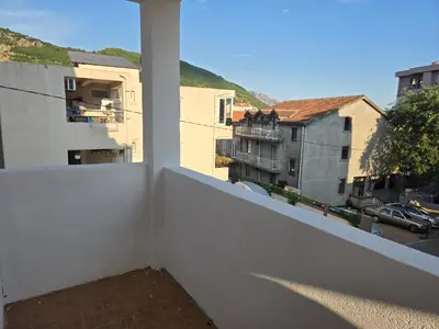 a white balcony with a view of a city at Тишина и покой в Будве in Kravlja