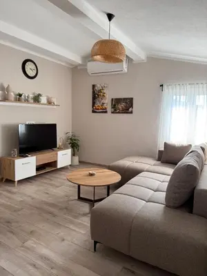 a living room with a couch and a table at Apartmani Krsto in Kravlja