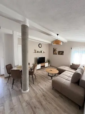 a living room with a couch and a table at Apartmani Krsto in Kravlja