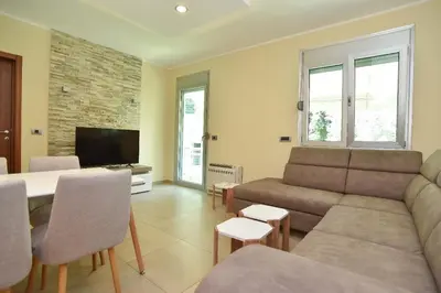 a living room with a couch and a table at Omega 4 Apartment in Budva
