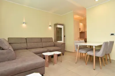 a living room with a couch and a table at Omega 4 Apartment in Budva